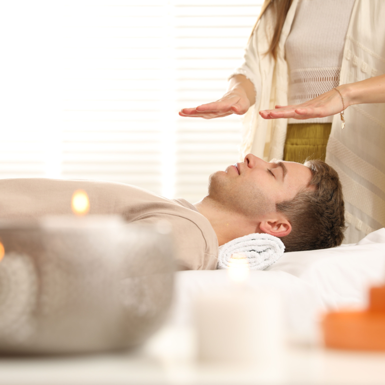 A person receiving a reiki healing therapy session in a tranquil setting.