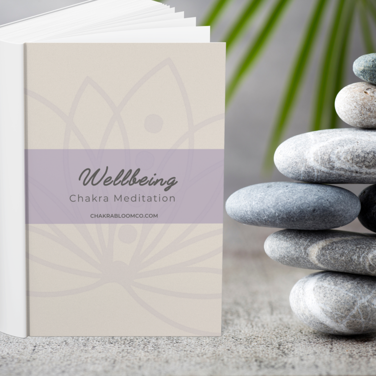 A stacked arrangement of smooth stones beside a wellbeing booklet on a textured surface.