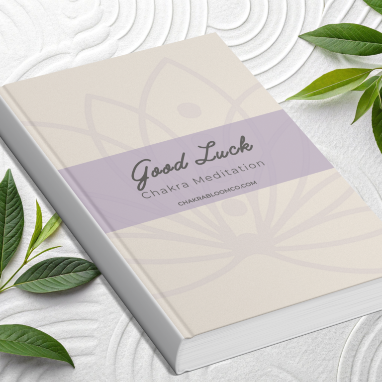 A light-coloured notebook with "Good Luck" on the cover, surrounded by green leaves.